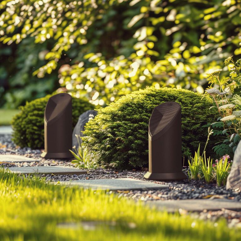 An outdoor Patio with speakers mounted on the support beams.