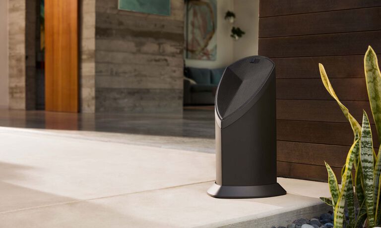 Speaker sitting subtly in front of a building.