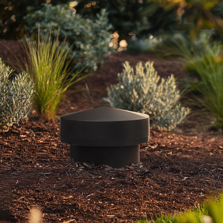 LS-100 installed in the ground surrounded by bushes